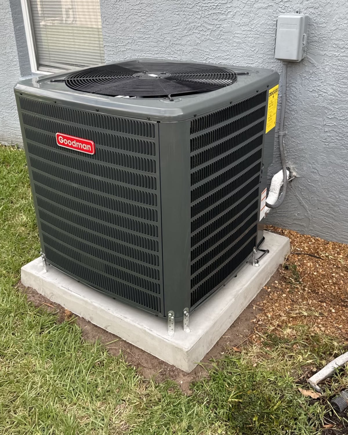Outdoor air-conditioning unit installed beside a home